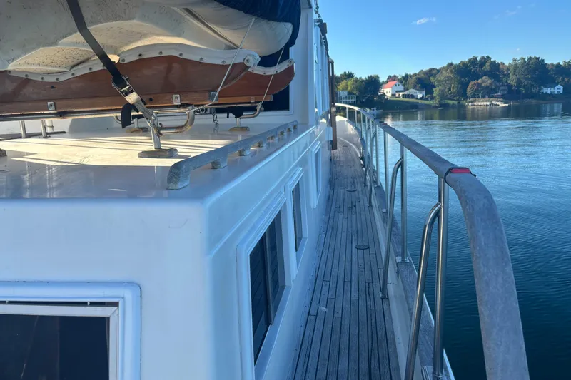 Maximon Yacht Photos Pics Side view of 1989 Grand Banks 46 yacht on calm water.