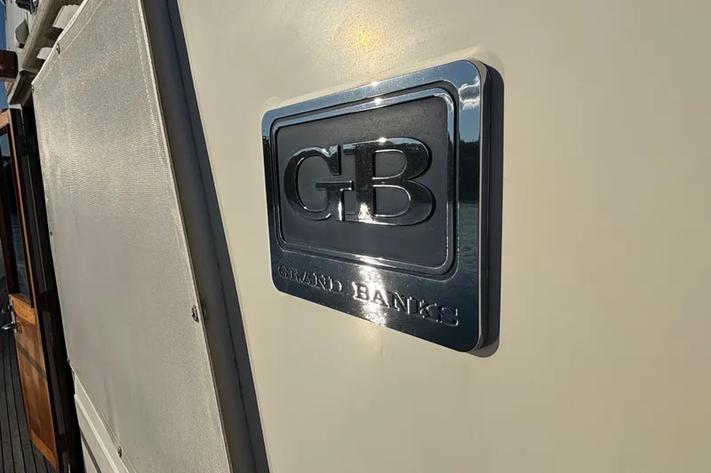 Maximon Yacht Photos Pics Grand Banks 46 yacht emblem, 1989 model, featuring polished metal logo.