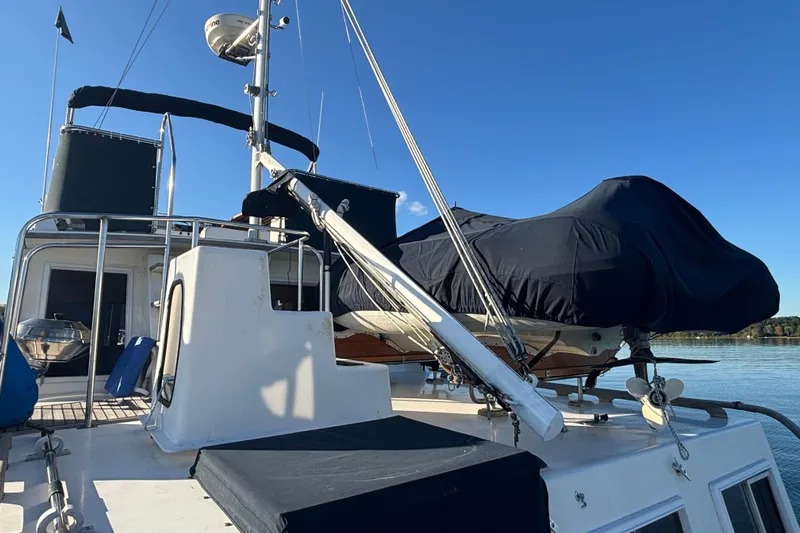 Maximon Yacht Photos Pics 1989 Grand Banks 46 yacht deck with covered equipment under clear blue sky.