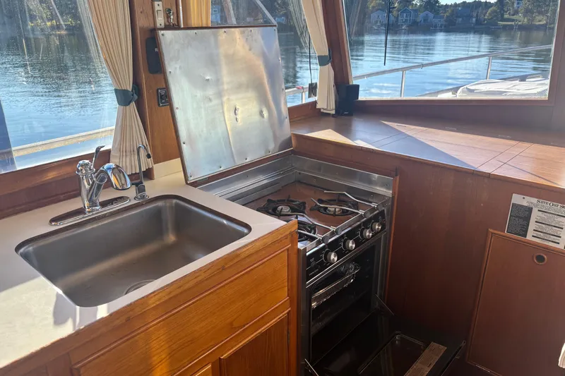 Maximon Yacht Photos Pics Interior of 1989 Grand Banks 46 yacht kitchen with stove and sink, overlooking water.