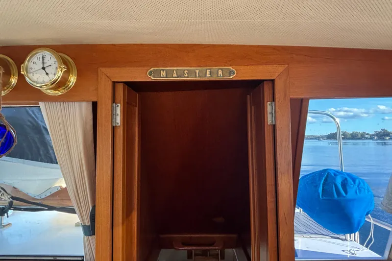 Maximon Yacht Photos Pics Interior view of 1989 Grand Banks 46 yacht, featuring a wooden master cabin door.
