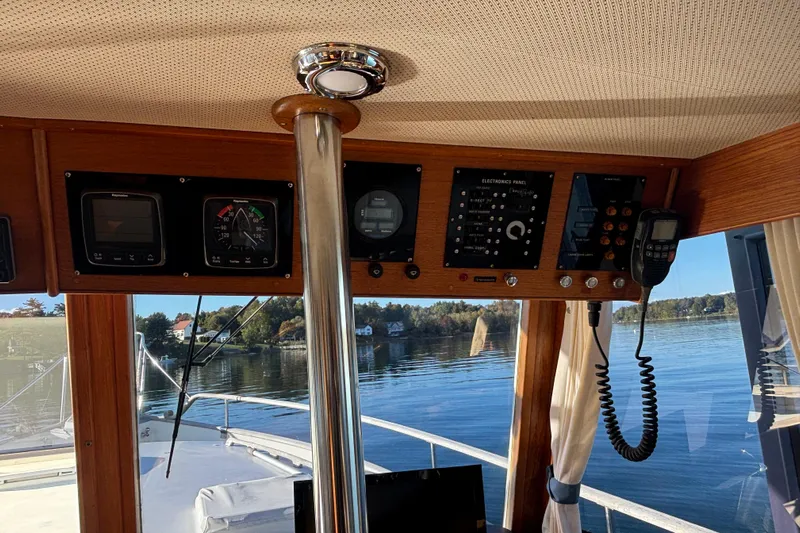 Maximon Yacht Photos Pics Interior view of 1989 Grand Banks 46 yacht helm with navigation instruments and serene water backdrop.