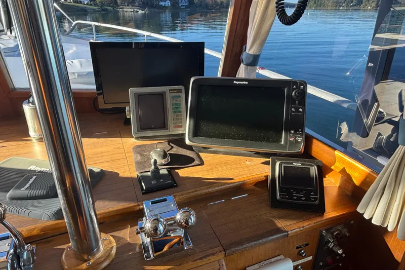 Maximon Yacht Photos Pics 1989 Grand Banks 46 yacht helm with navigation equipment and scenic water view.