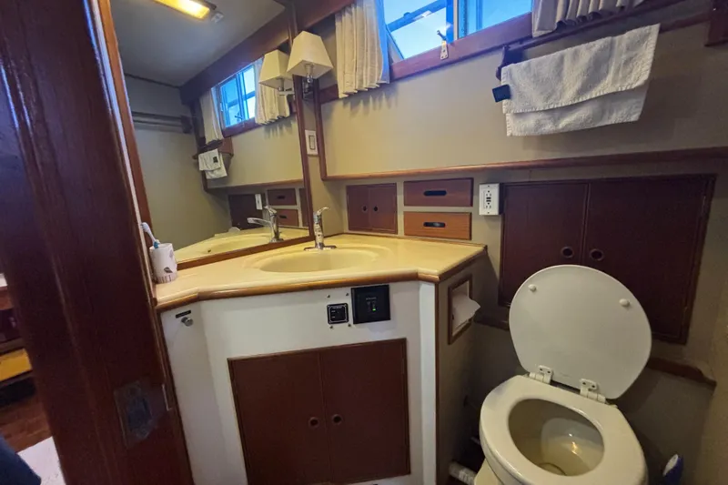 Maximon Yacht Photos Pics Bathroom interior of 1989 Grand Banks 46 yacht, featuring sink and toilet.