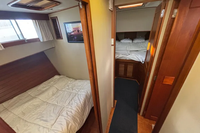 Maximon Yacht Photos Pics Interior of 1989 Grand Banks 46 yacht showing cozy bedrooms with wooden accents.
