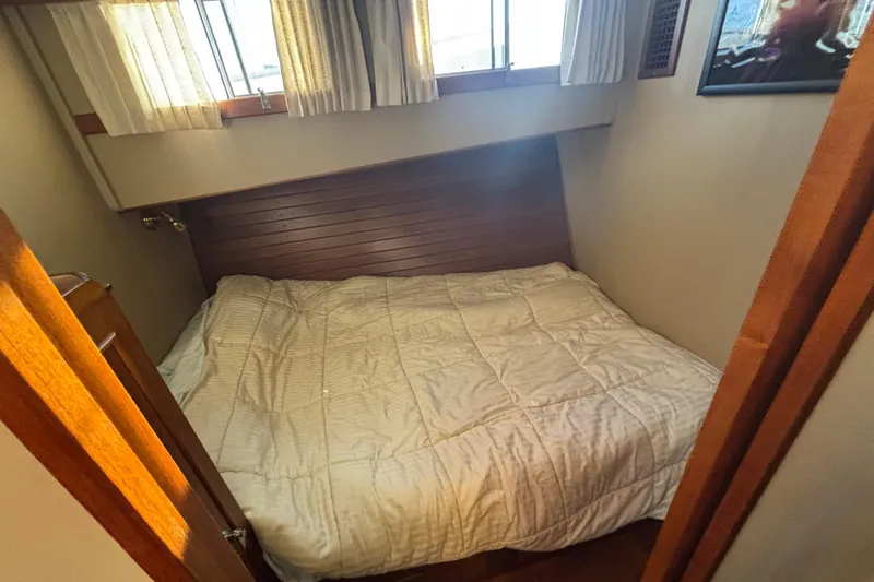 Maximon Yacht Photos Pics Cozy bedroom interior of 1989 Grand Banks 46 yacht with wooden accents and natural light.