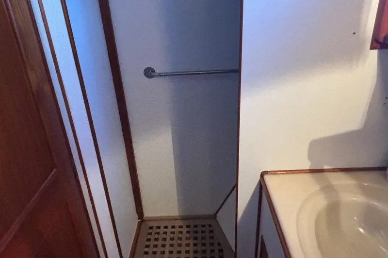 Maximon Yacht Photos Pics Shower area in 1989 Grand Banks 46 yacht with wooden accents and sink.
