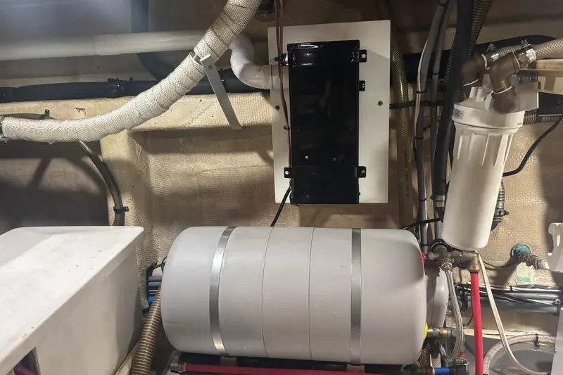 Maximon Yacht Photos Pics Engine room of 1989 Grand Banks 46 yacht, featuring mechanical components and piping.