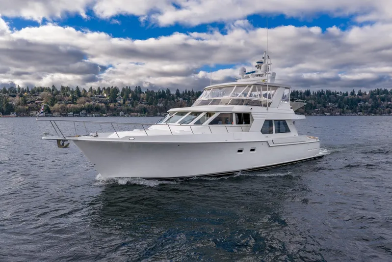 Odisea Yacht Photos Pics 1995 Tollycraft 57 Walk Around Pilothouse yacht cruising on a scenic lake.