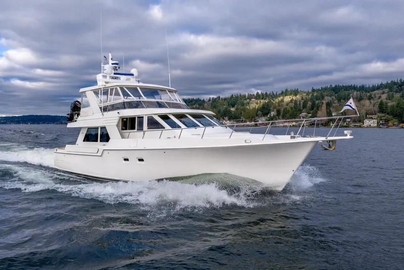 Odisea Yacht Photos Pics 1995 Tollycraft 57 Walk Around Pilothouse yacht cruising on a scenic lake.