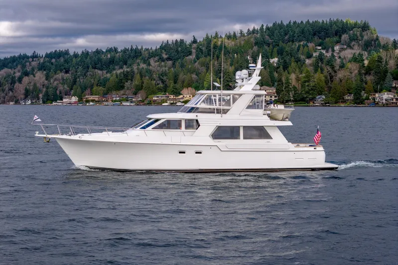 Odisea Yacht Photos Pics 1995 Tollycraft 57 Walk Around Pilothouse yacht cruising on a scenic lake.