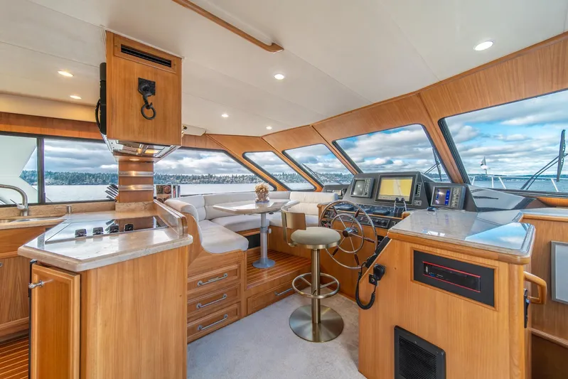 Odisea Yacht Photos Pics Luxurious 1995 Tollycraft 57 Walk Around Pilothouse interior with modern navigation equipment.