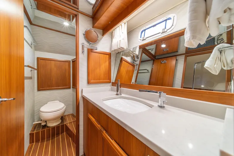 Odisea Yacht Photos Pics Luxurious 1995 Tollycraft 57 yacht bathroom with wood accents and modern fixtures.