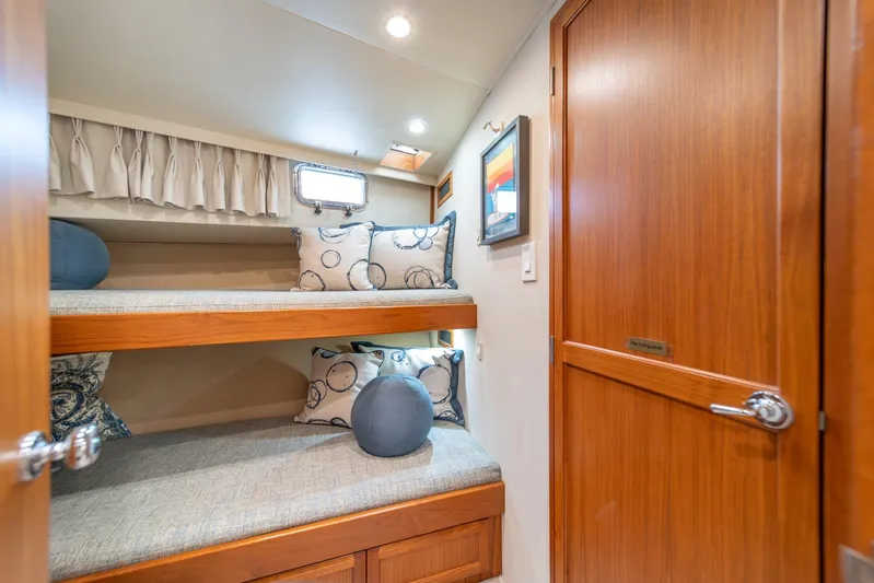 Odisea Yacht Photos Pics Cozy cabin interior of 1995 Tollycraft 57 Walk Around Pilothouse with bunk beds and wooden finishes.