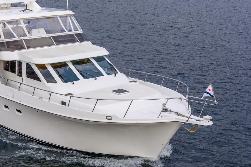 Odisea Yacht Photos Pics 1995 Tollycraft 57 Walk Around Pilothouse yacht cruising on open water.