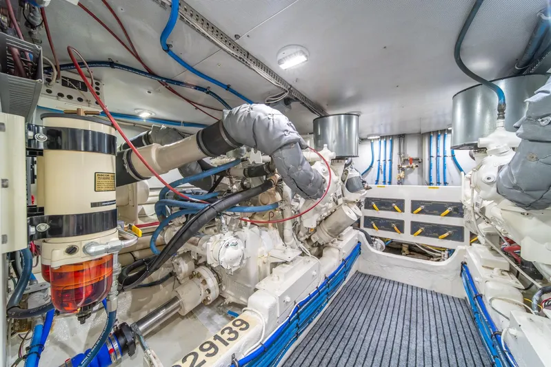 Odisea Yacht Photos Pics Engine room of 1995 Tollycraft 57 Walk Around Pilothouse with visible machinery and wiring.