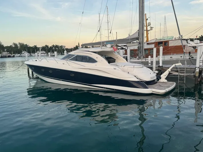 Fleur Du Cap A Yacht Photos Pics Sunseeker Predator 60 yacht, 2000 model, docked in a serene marina setting.