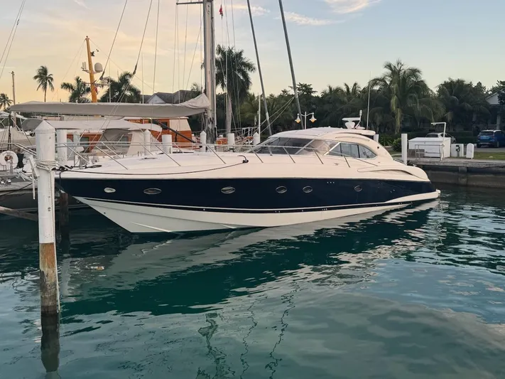 Fleur Du Cap A Yacht Photos Pics Sunseeker Predator 60 yacht, 2000 model, docked in a serene marina setting.