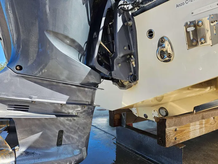  Yacht Photos Pics Close-up of a 2012 Edgewater 318CC boat engine and transom on a stand.