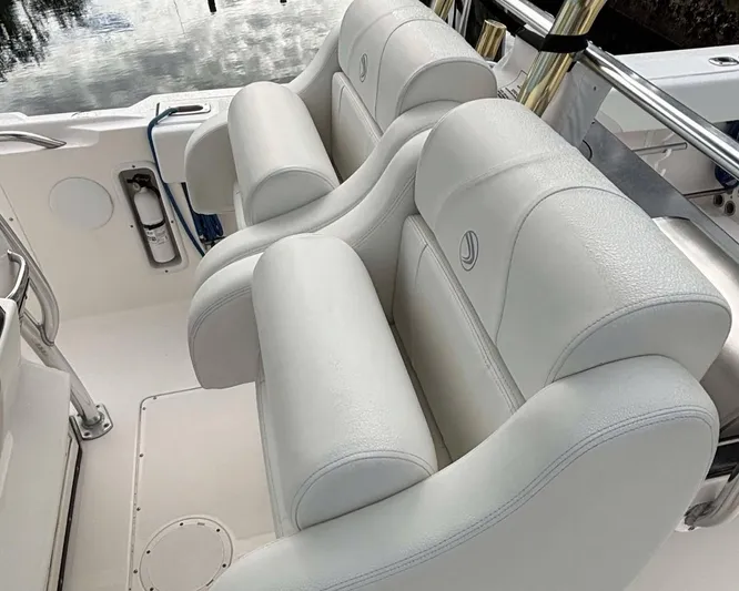  Yacht Photos Pics 2012 Edgewater 318CC boat with white leather seating and polished metal accents.