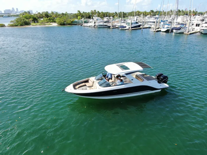  Yacht Photos Pics 2018 Sea Ray 310 SLX boat cruising on a serene marina with lush greenery.