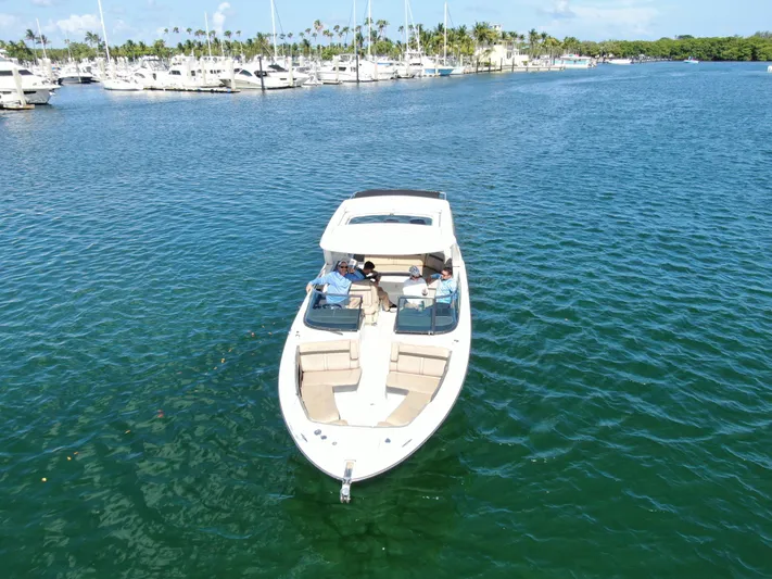  Yacht Photos Pics 2018 Sea Ray 310 SLX boat cruising in a marina with people onboard.