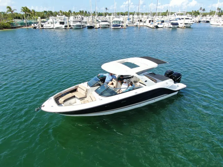  Yacht Photos Pics 2018 Sea Ray 310 SLX boat cruising on a sunny day near a marina.