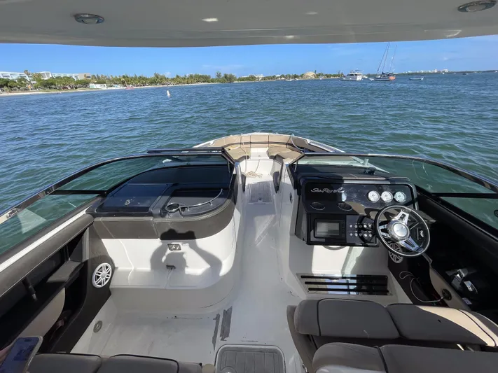  Yacht Photos Pics 2018 Sea Ray 310 SLX boat interior with steering wheel, dashboard, and open water view.