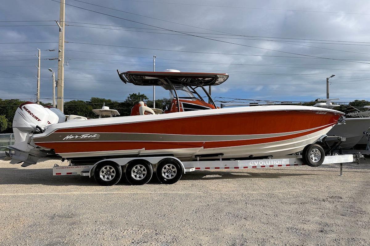 2016 Nor-Tech 340 Sport Center Console boat on trailer, side view.