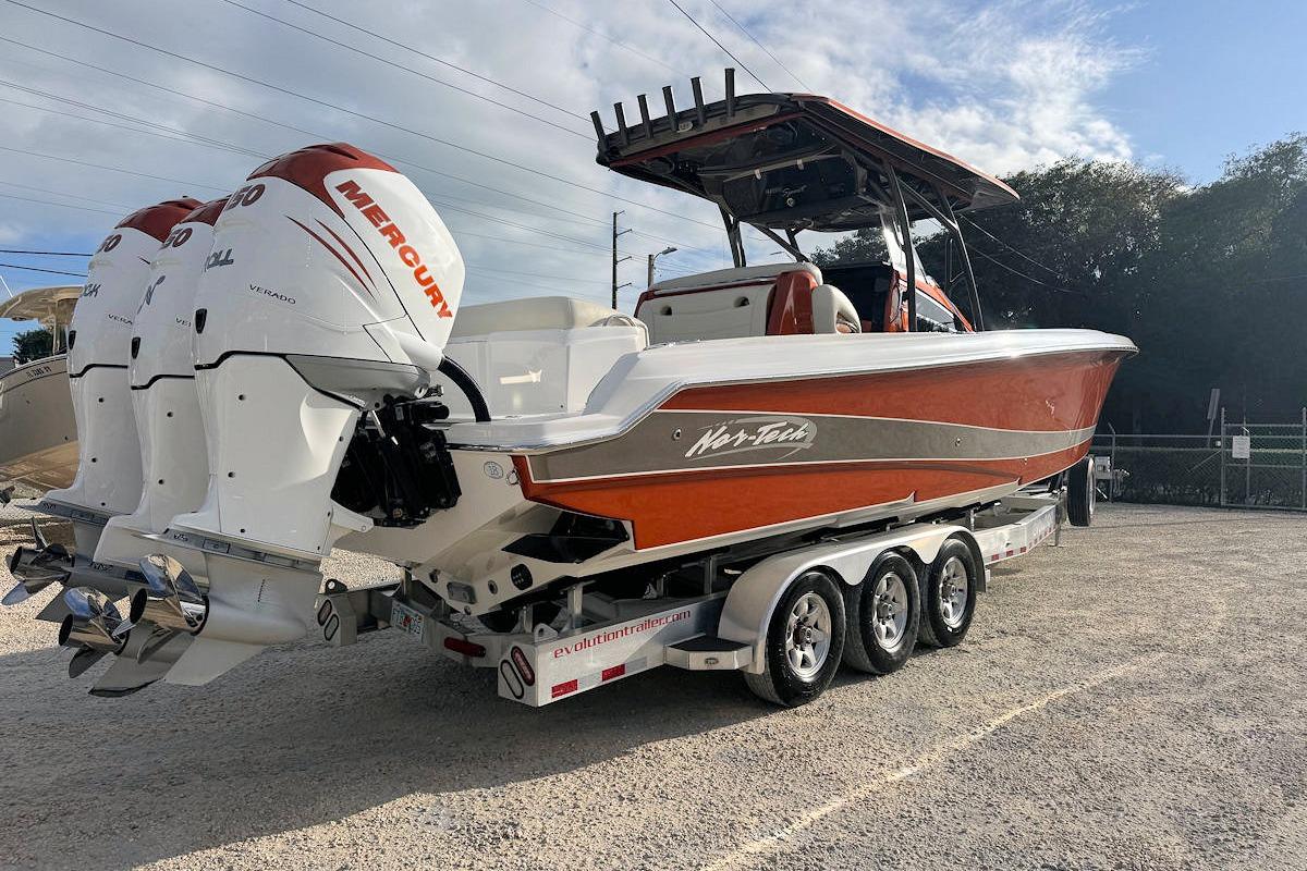 2016 Nor-Tech 340 Sport Center Console boat with triple Mercury engines on a trailer.