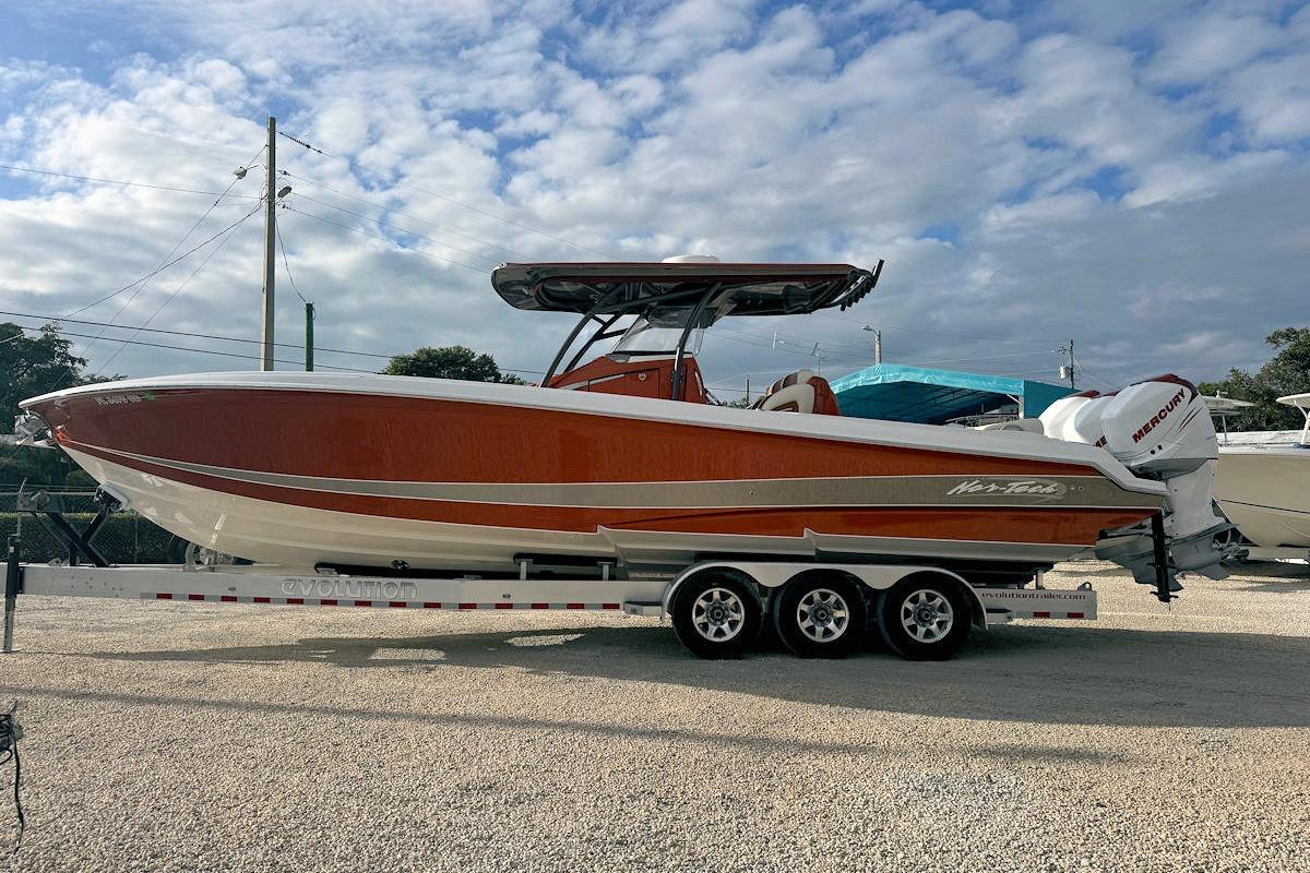 2016 Nor-Tech 340 Sport Center Console boat on trailer, under cloudy sky.