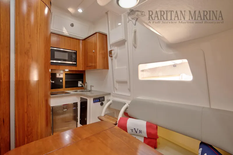 Thunder Reef V Yacht Photos Pics Interior of 2016 Regulator 41 boat with kitchenette and seating area.