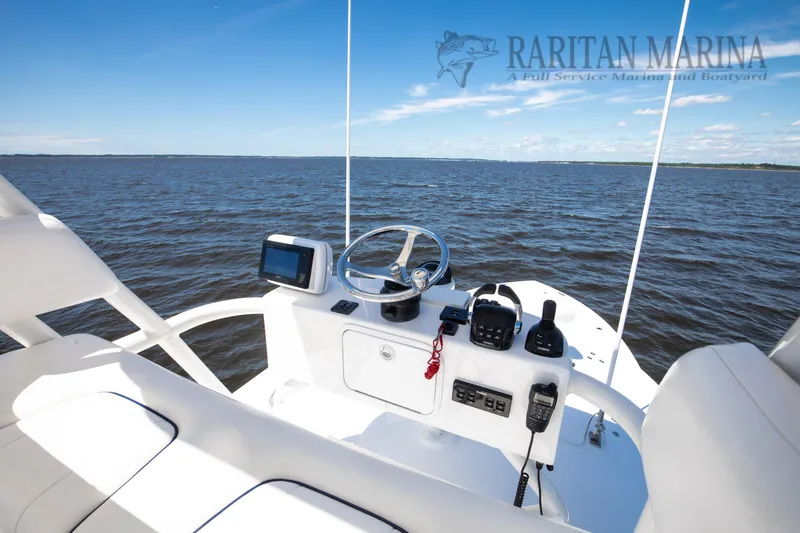 Thunder Reef V Yacht Photos Pics 2016 Regulator 41 boat helm with ocean view, featuring navigation equipment.