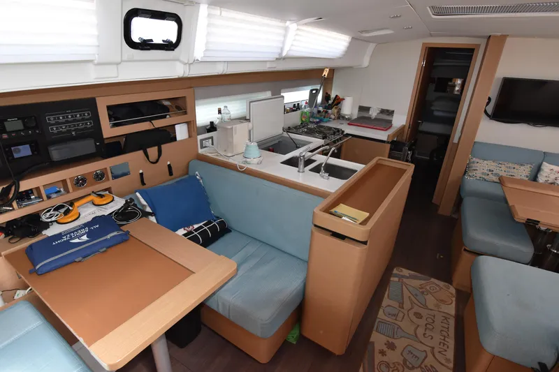 Blueconomy Yacht Photos Pics Interior of 2020 Jeanneau Sun Odyssey 490 yacht, featuring modern kitchen and seating area.