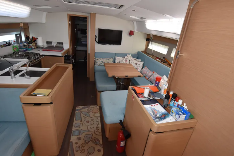 Blueconomy Yacht Photos Pics Interior of 2020 Jeanneau Sun Odyssey 490 yacht with modern kitchen and cozy seating area.