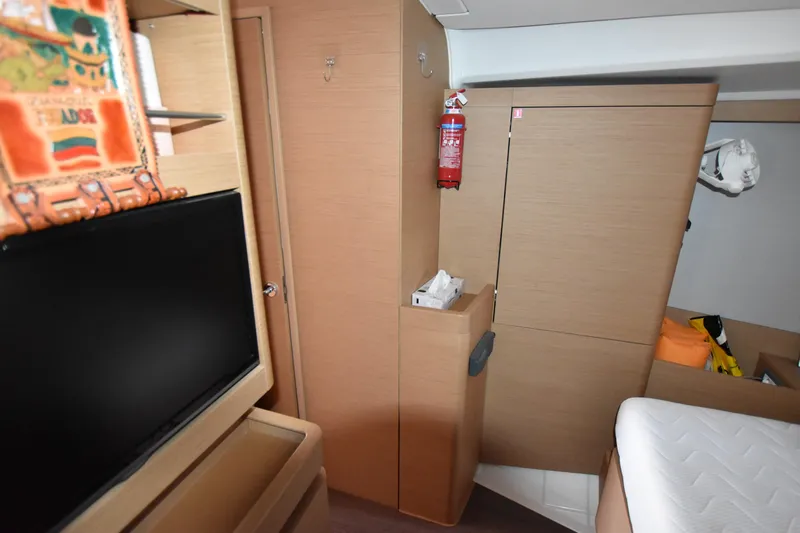 Blueconomy Yacht Photos Pics Interior of 2020 Jeanneau Sun Odyssey 490 yacht with modern furnishings and a TV.