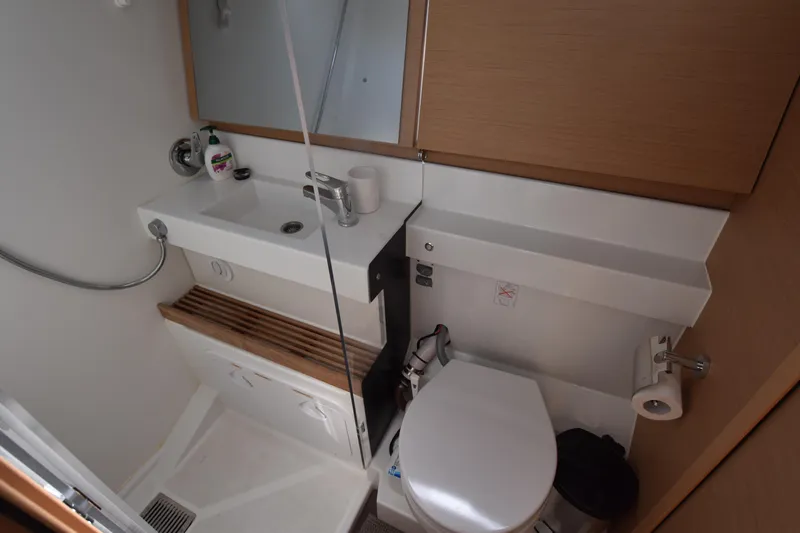 Blueconomy Yacht Photos Pics Modern bathroom in 2020 Jeanneau Sun Odyssey 490 yacht, featuring sink and toilet.