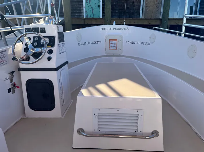 Joseph Packer Yacht Photos Pics 2024 Duffy 26 Water Taxi interior with steering console and safety equipment.