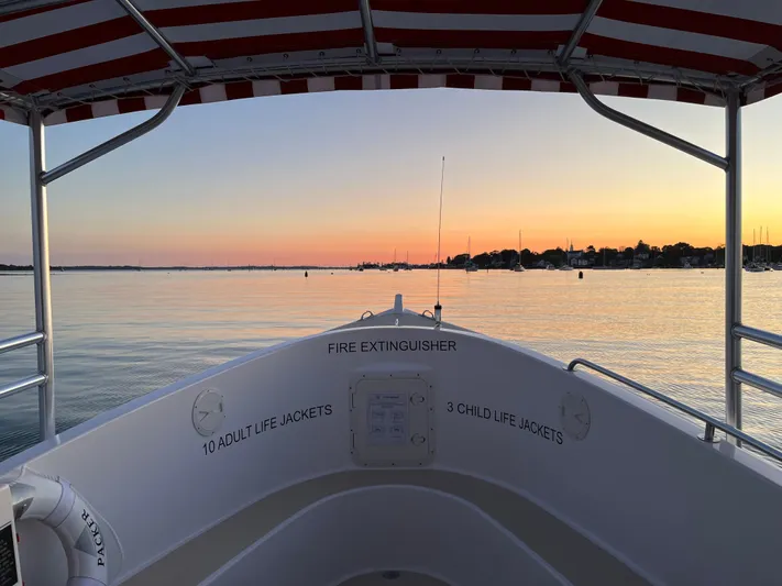Joseph Packer Yacht Photos Pics 2024 Duffy 26 Water Taxi at sunset, featuring safety equipment and calm waters.
