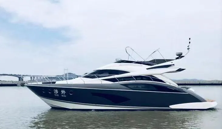  Yacht Photos Pics 2011 Marquis 500 Sport Bridge yacht on calm water, side view.