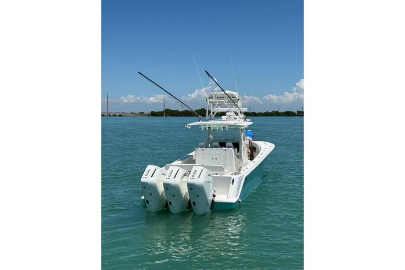  Yacht Photos Pics 2024 SeaVee 370z boat with triple engines on clear blue water.