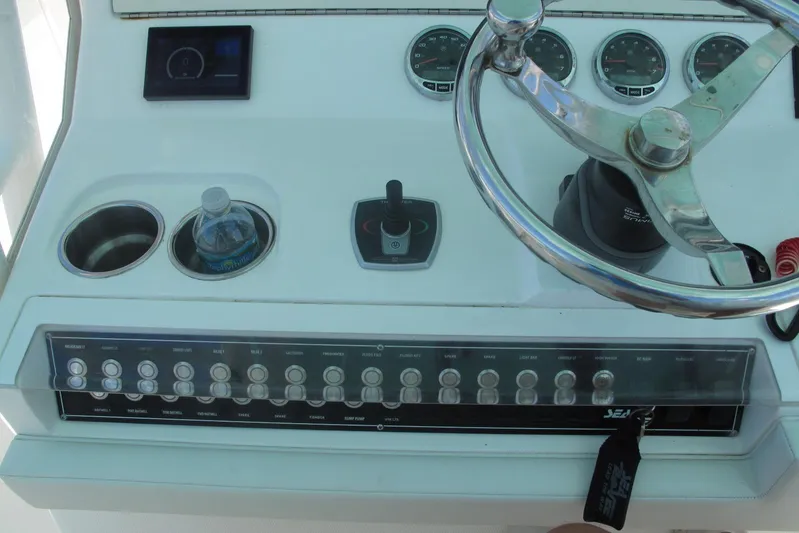  Yacht Photos Pics 2024 SeaVee 370z boat dashboard with steering wheel and control panel.