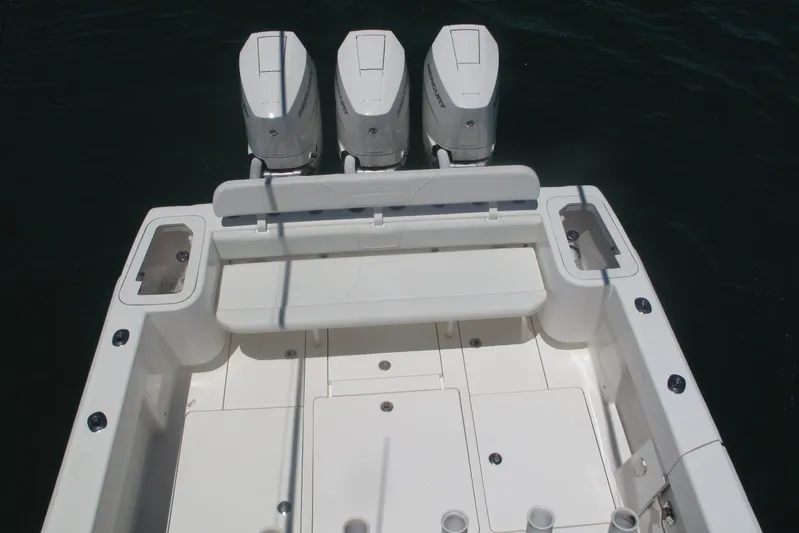  Yacht Photos Pics 2024 SeaVee 370z boat with triple outboard engines, spacious deck, and seating area.