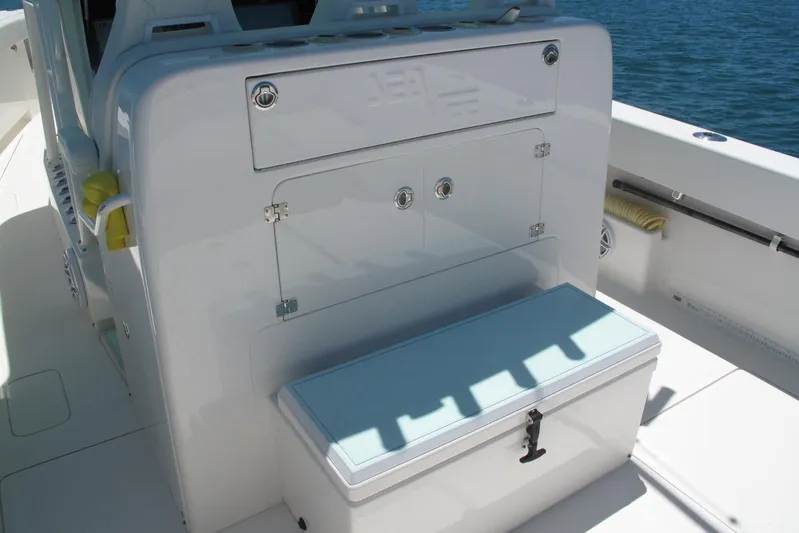  Yacht Photos Pics 2024 SeaVee 370z boat interior with storage compartment and seating, on calm water.