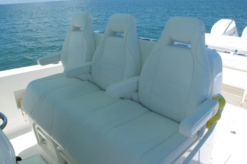  Yacht Photos Pics 2024 SeaVee 370z boat with luxurious white seating, ocean backdrop.