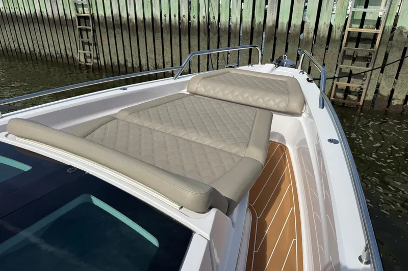  Yacht Photos Pics 2022 Axopar 37 XC CROSS CABIN boat with cushioned sun deck by the dock.