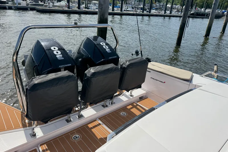  Yacht Photos Pics 2022 Axopar 37 XC CROSS CABIN with twin Mercury outboard engines at a marina.
