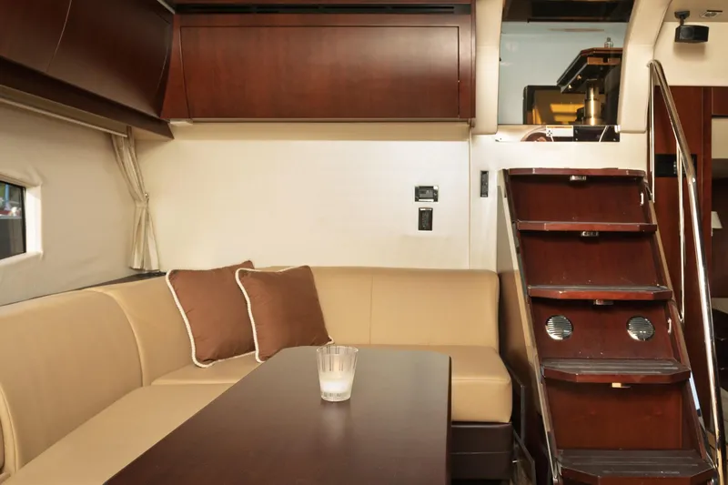  Yacht Photos Pics Luxurious interior of 2015 Regal 53 Sport Coupe with elegant seating and wooden stairs.