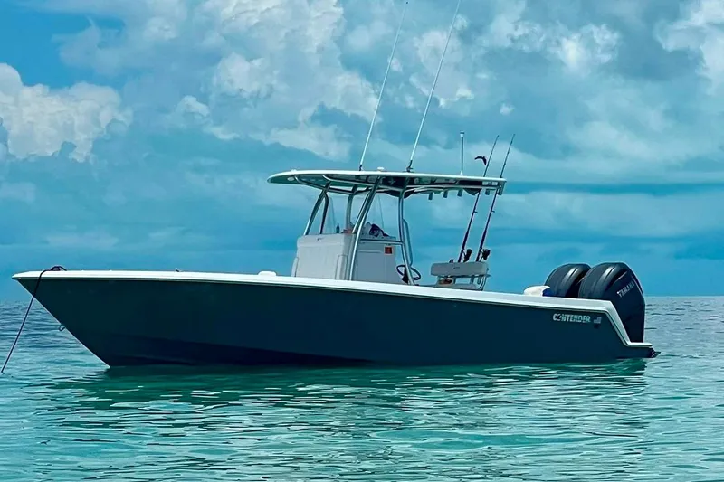  Yacht Photos Pics 2023 Contender 30 Tournament boat on calm ocean waters under a cloudy sky.