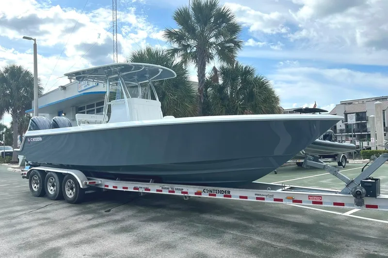  Yacht Photos Pics 2023 Contender 30 Tournament boat on trailer, parked outdoors under cloudy sky.